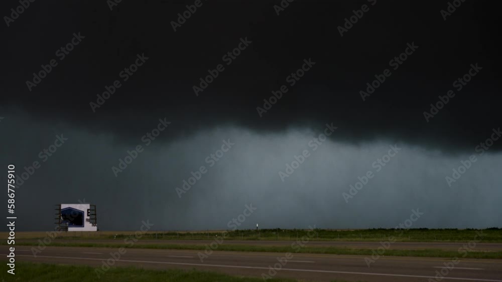 Scary Highway Storm Turns the Sky Black as Cars Pass Along a Busy Highway