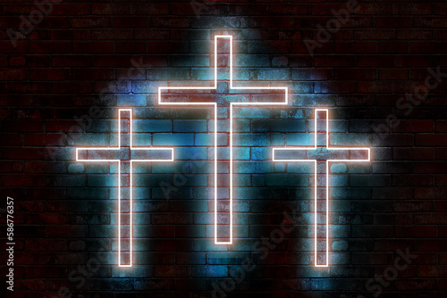 Glowing crosses on the background of a brick wall. Neon crosses.
