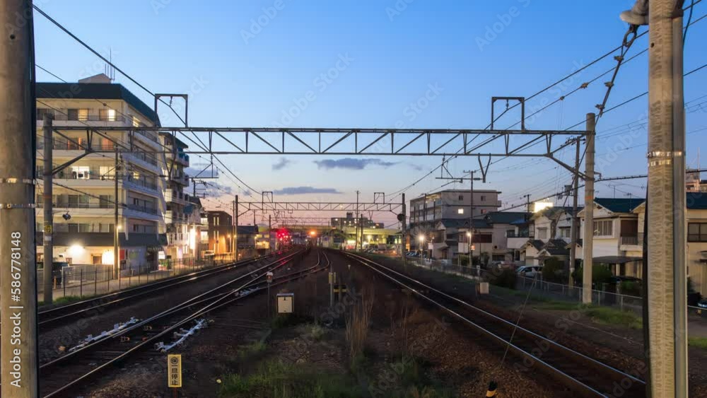 Time Lapse: Trains speed down tracks in residential neighborhood at sunset Time Lapse: Trains speed down tracks in residential neighborhood at sunset