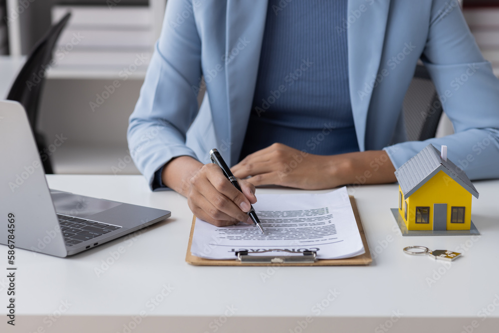 Fototapeta premium Real estate broker agent presenting and consult to customer to decision making sign insurance form agreement, buy and sell home model, concerning mortgage loan offer for and house insurance