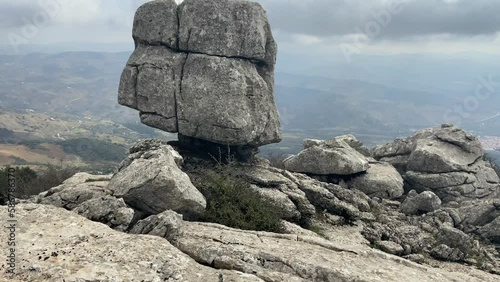 Touring mountainous karstic landscape in the Torcal de Antequera with rocky silhouettes with a fine mist.