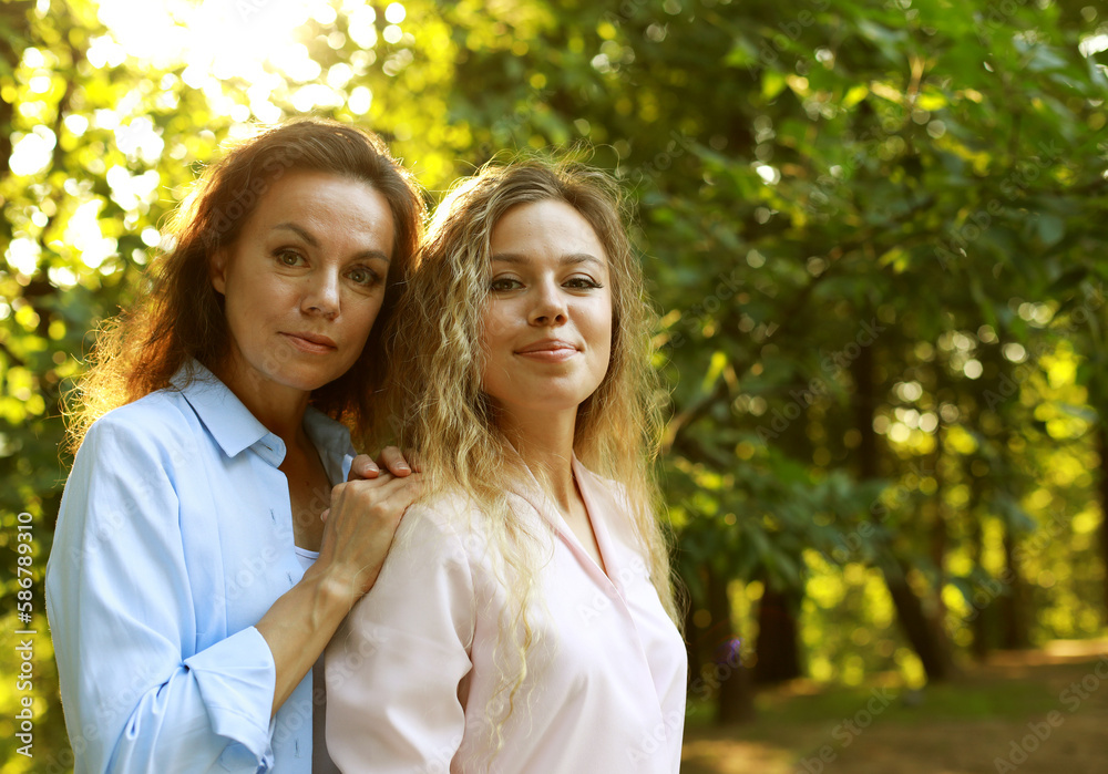portrait of mother and daughter hugging, summer time, park portrait of mother and daughter hugging, summer time, park