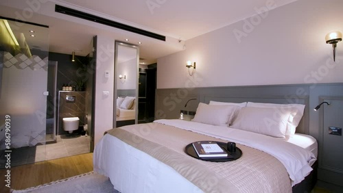 Establish modern hotel room with big bed and luxurious bathroom, rotate photo