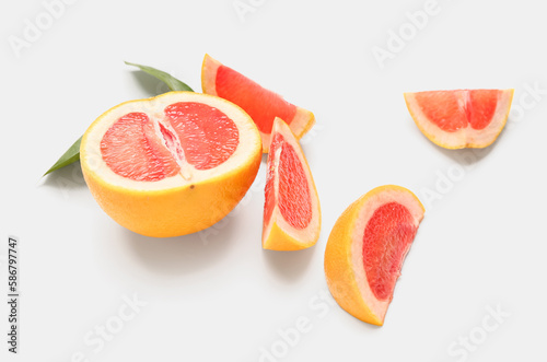 Pieces of ripe grapefruit on white background