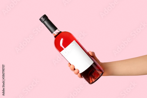 Female hand holding bottle ...