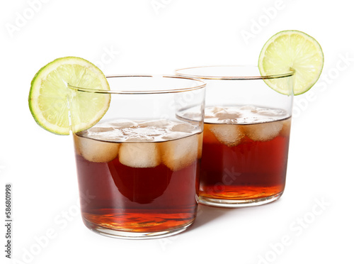 Glasses of cold rum with lime on white background