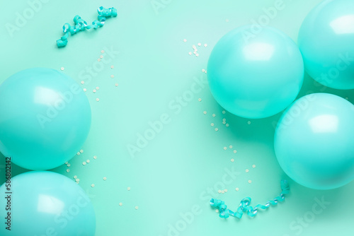 Frame made of blue balloons, ribbons and serpentine on color background