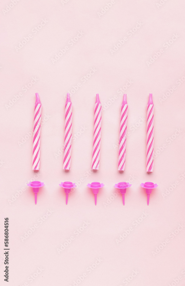 Birthday candles on pink background