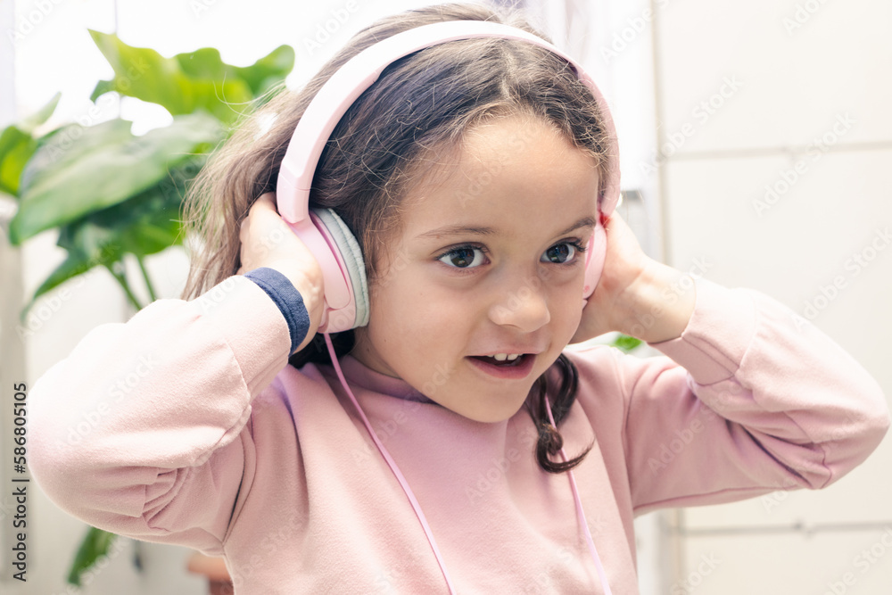 girl enjoying the music with pink headphones girl enjoying the music with pink headphones