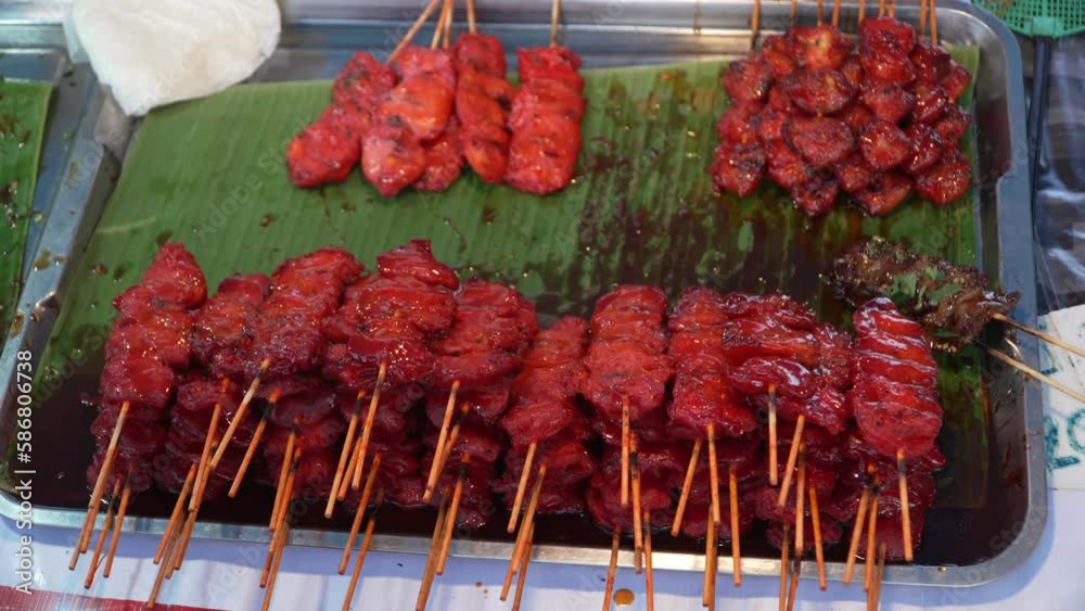 Skewered grilled chicken on the shelf. Thai street food