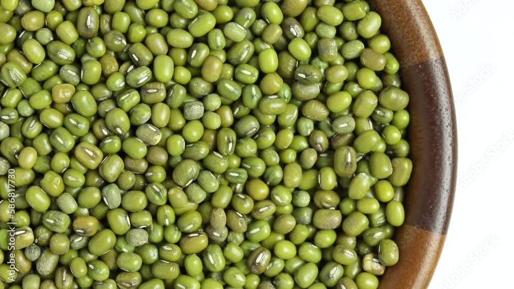 mung bean in wooden bowl rotating on white background, top view. mung bean in wooden bowl rotating on white background, top view.