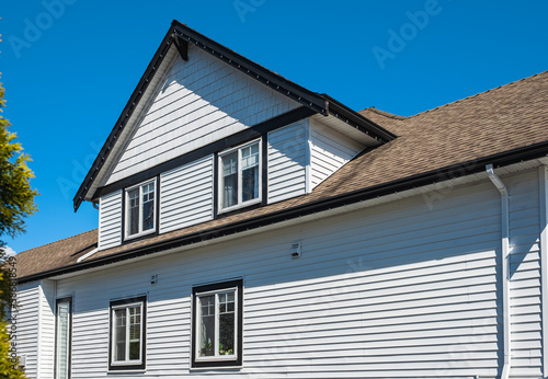 Facade of a house with nice windows in the blue sky background. Beautiful Home Exterior. Real Estate Exterior