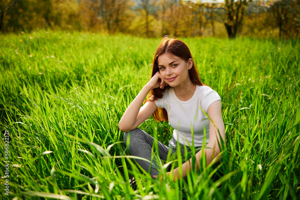 Beautiful healthy Young Woman relaxing on the green grass Beautiful healthy Young Woman relaxing on the green grass