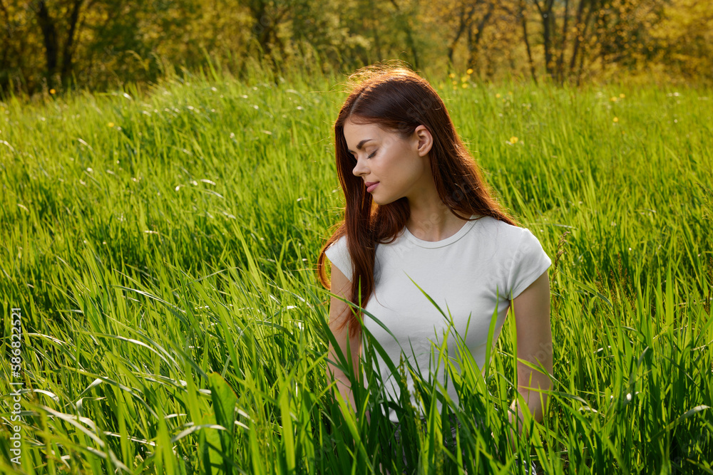 happy cheerful woman laying in green grass happy cheerful woman laying in green grass