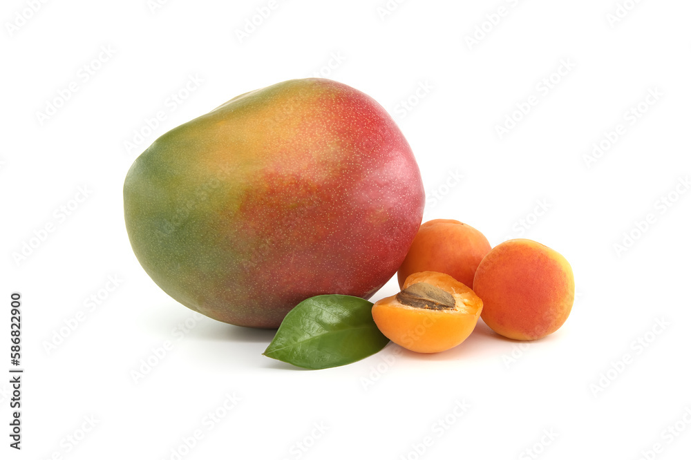 Mango, whole and halved ripe apricot fruits on white Mango, whole and halved ripe apricot fruits on white