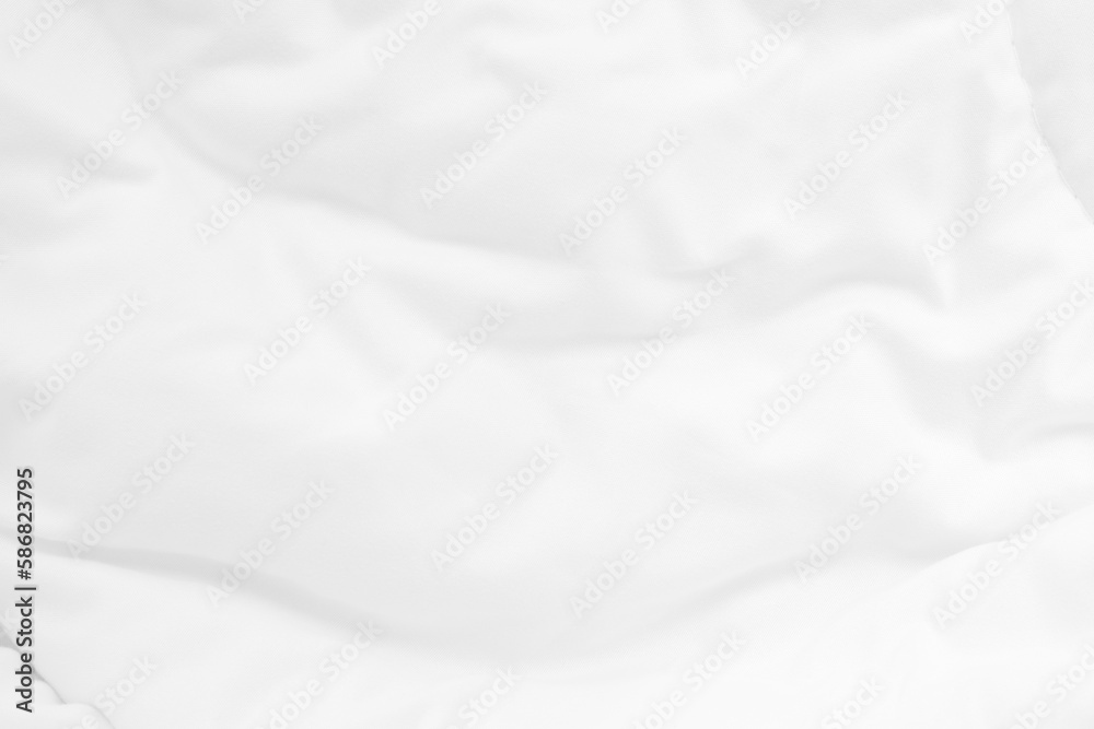 Close up top view of white bedding sheet and wrinkle messy blanket in bedroom after wake up in the morning.