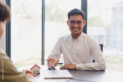 Close up Business people or Real Estate agent explain signing agreement for sale house to client. Property, Insurance, Broker concept