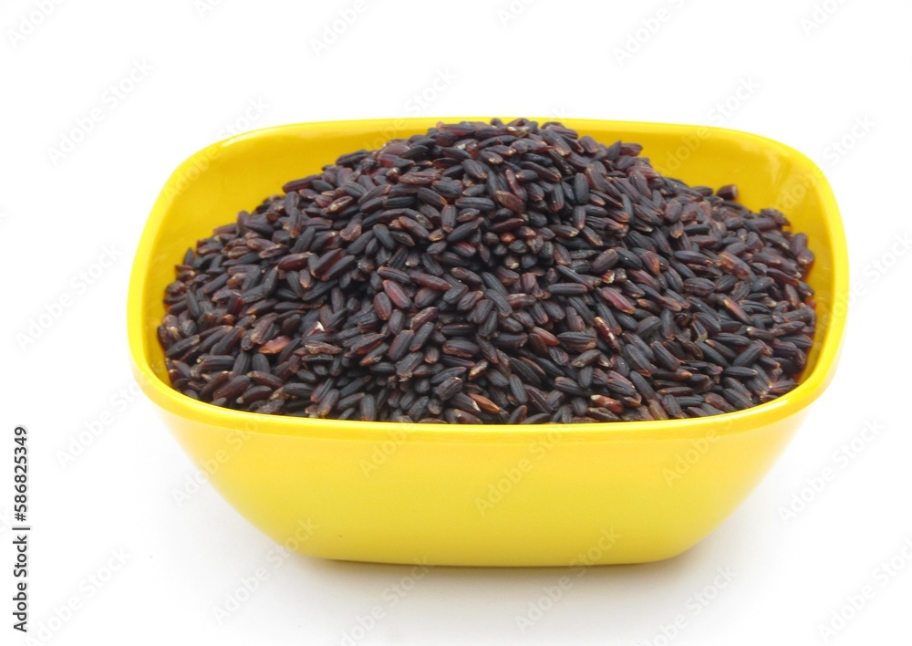 Black rice in a bowl on white background Black rice in a bowl on white background