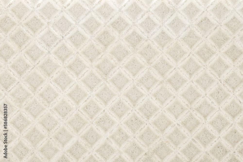 Fototapeta premium Waffle biscuit close-up background mesh surface, background wallpaper, uniform texture pattern