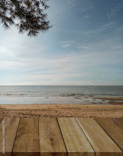 Wood table top on blur beach and sea background - can be used for display or montage your products.