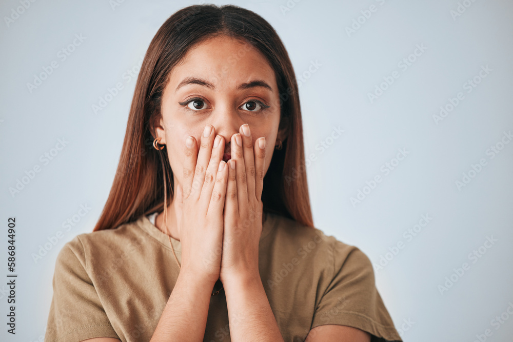 Portrait, woman and surprise in a studio with a female cover mouth from shock. Isolated, grey background and hands on a face of a young person model with wow, worry and alert reaction from secret Portrait, woman and surprise in a studio with a female cover mouth from shock. Isolated, grey background and hands on a face of a young person model with wow, worry and alert reaction from secret