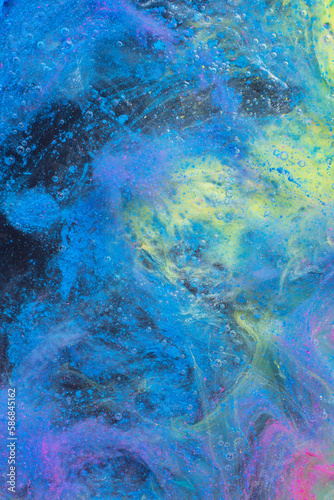 Photo of beautiful mixtures of blue colorful substances in the deep space. Abstract texture of colorful splashes. Expressive swirls.