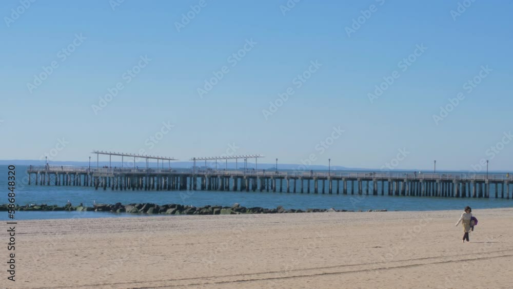 Woman Walking in Coney Island Beach New York Woman Walking in Coney Island Beach New York
