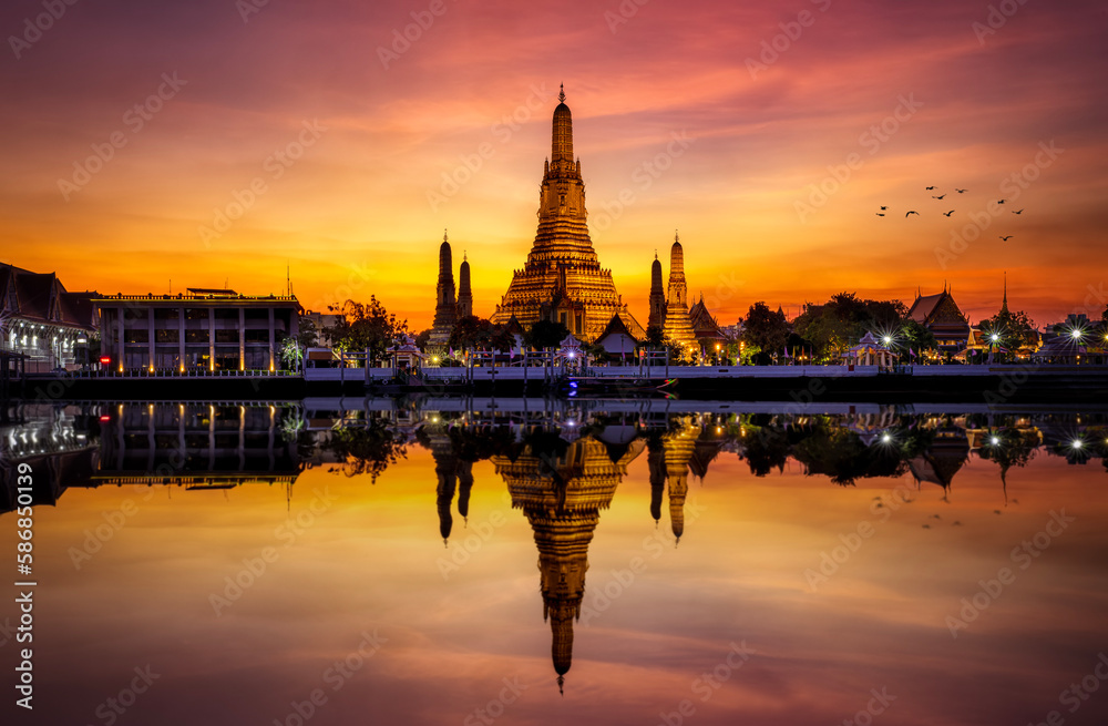The famous Buddhist Temple Wat Arun during dusk with reflections in the Chao Phraya Rriver, Bangkok, Thailand