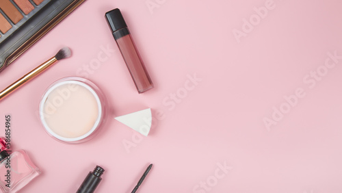 Beauty cosmetic makeup background. Fashionable women's cosmetics, brushes, lipstick, sponge, powder, eye shadow. Creative blure concept. Cosmetology accessories banner, top view. Copy space