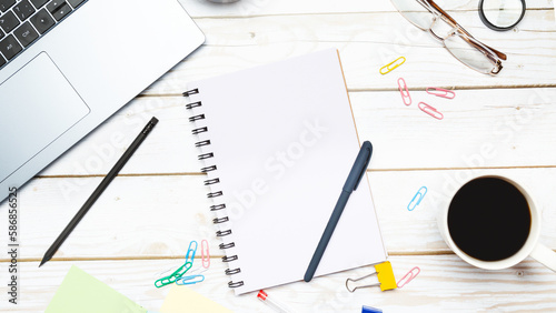 Modern workspace with coffee cup, keyboard and notebook on wooden background. Top view. Flat lay