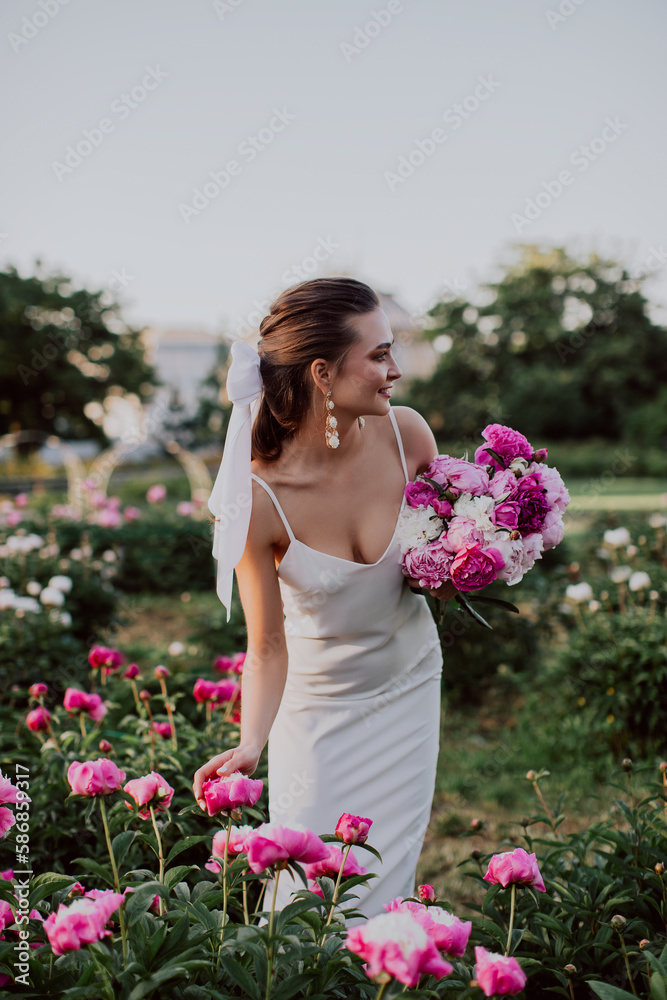 young woman with pink peonies young woman with pink peonies
