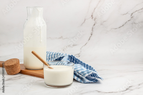 Foto Organic probiotic kefir drink on a light background