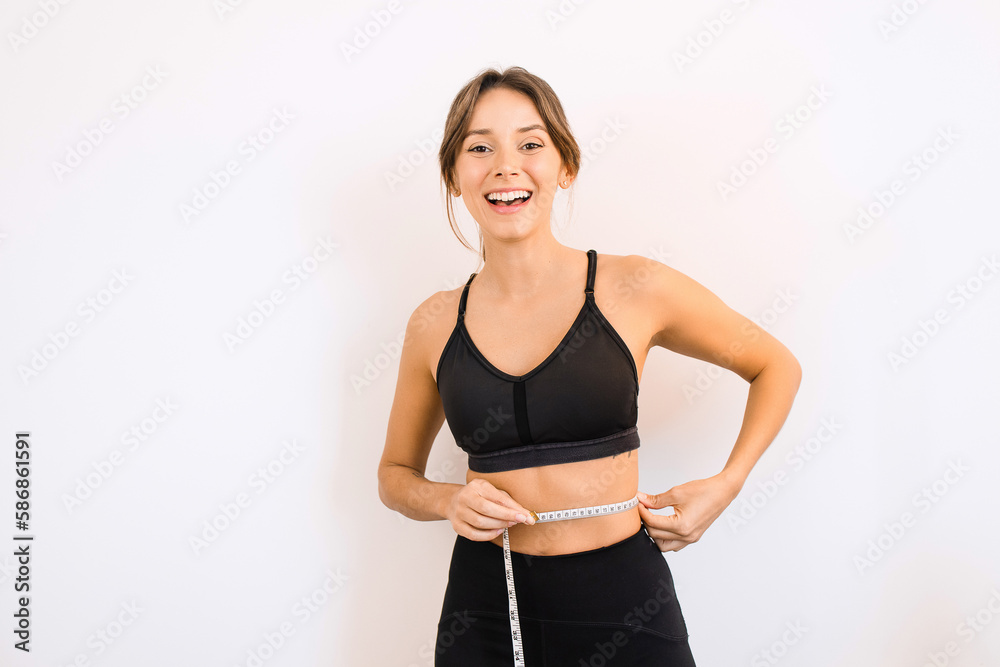 Young Happy Sporty Woman Holding a Measuring Tape Feeling Happy with Weight Loss Muscle Gain