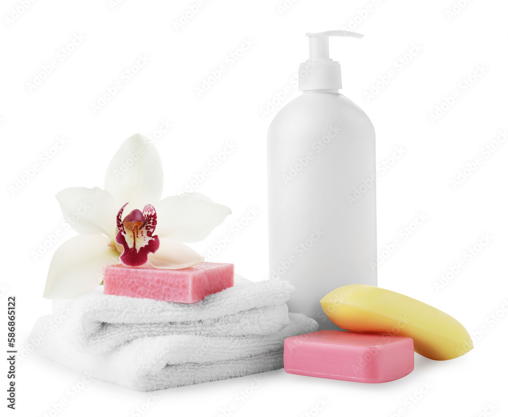 Different soap bars, bottle dispenser and terry towels on white background Different soap bars, bottle dispenser and terry towels on white background