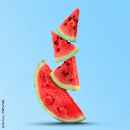 Stack of juicy watermelon slices on light blue background