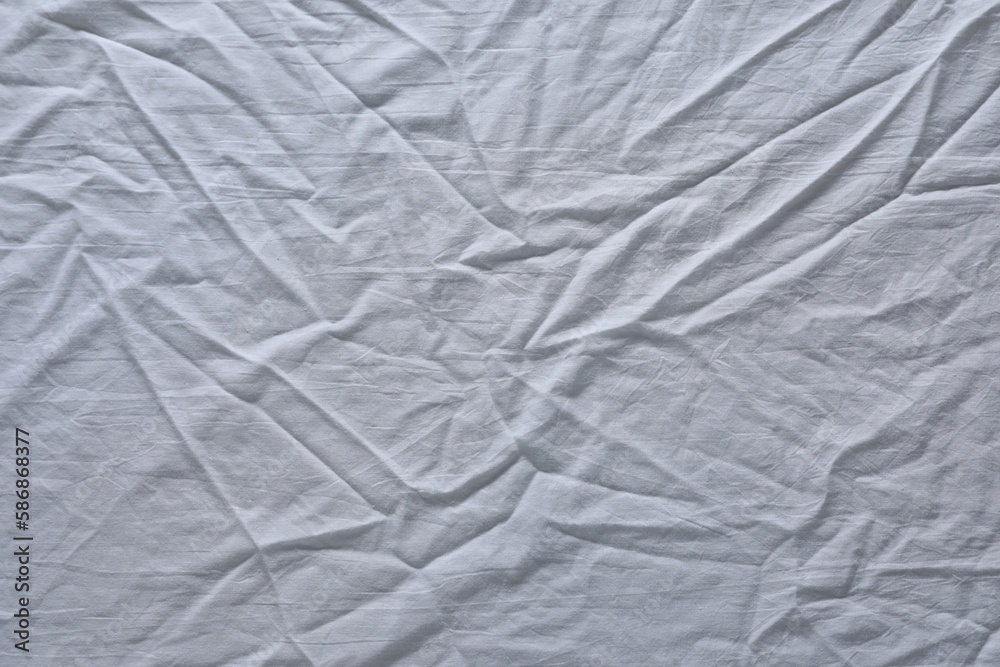 Crumpled white fabric as background, top view Crumpled white fabric as background, top view