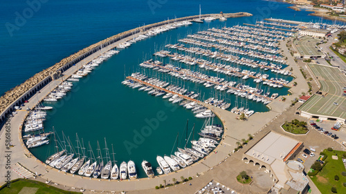 Aerial view of Tourist Port of Riva di Traiano located in Civitavecchia, near Rome, Italy. There are many boats moored at the marina.