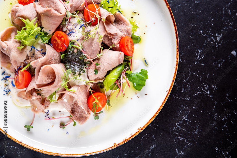 Beef tongue salad with fresh vegetables in plate Beef tongue salad with fresh vegetables in plate