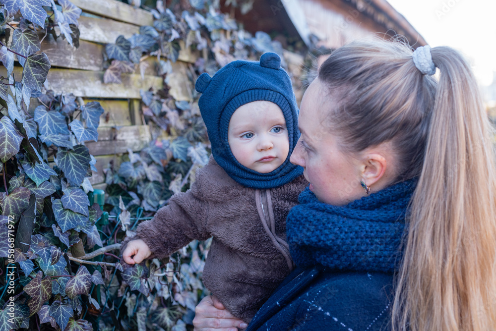 Obraz premium Woman holding baby in her hands. Mother and son.
