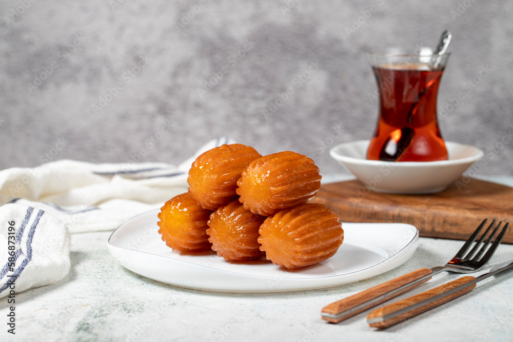 Tulumba dessert. Ramadan sweets. Traditional Turkish cuisine delicacies. Tulumba dessert with syrup on a gray background. Tulumba dessert. Ramadan sweets. Traditional Turkish cuisine delicacies. Tulumba dessert with syrup on a gray background.