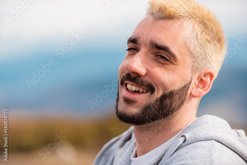 Portrait Of Young Handsome Man Smiling Outdside. photo