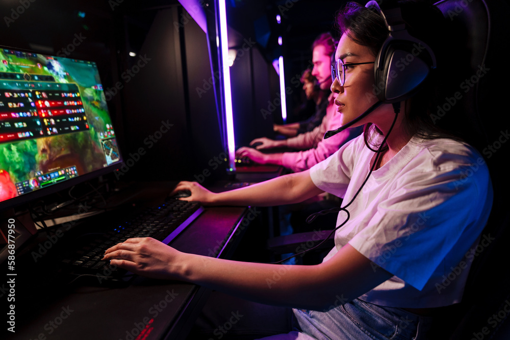 Team of gamers playing online game on championship in cybersport club Team of gamers playing online game on championship in cybersport club