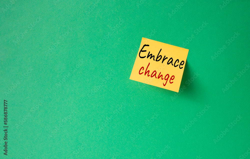 Embrace change symbol. Orange steaky note with concept words Embrace change. Beautiful green background. Business and Embrace change concept. Copy space Embrace change symbol. Orange steaky note with concept words Embrace change. Beautiful green background. Business and Embrace change concept. Copy space