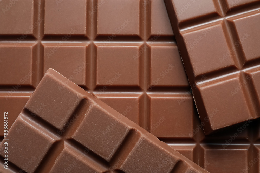 Delicious milk chocolate bars as background, top view Delicious milk chocolate bars as background, top view