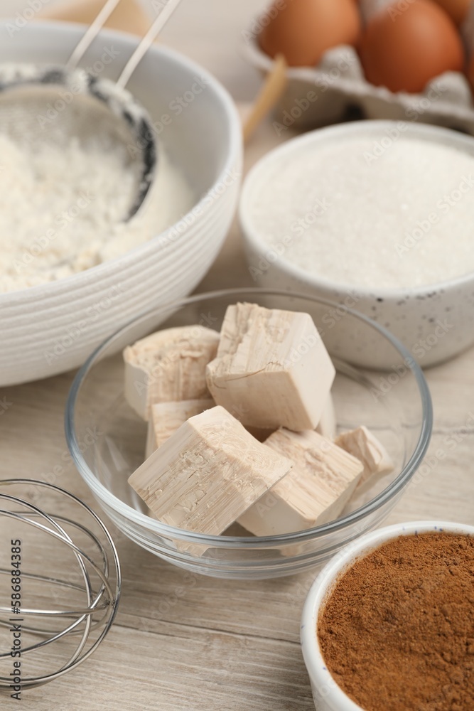 Flour, yeast cake and different ingredients on white wooden table. Making pie Flour, yeast cake and different ingredients on white wooden table. Making pie