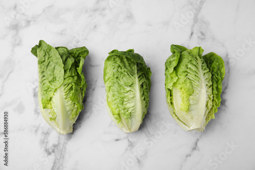 Bilde på lerret Fresh green romaine lettuces on white marble table, flat lay
