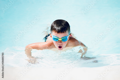 little boy swimming in the pool