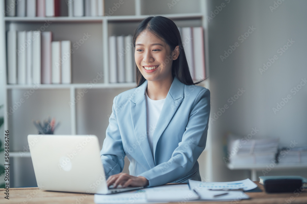 Asian businesswoman talking on phone, using laptop, looking at screen, entrepreneur manager consulting client by call, looking at computer screen, discussing Asian businesswoman talking on phone, using laptop, looking at screen, entrepreneur manager consulting client by call, looking at computer screen, discussing
