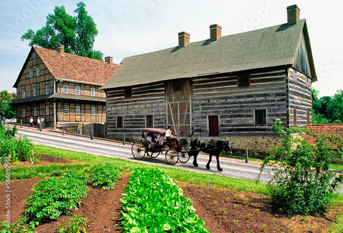 Obraz na płótnie Moravian religious community of Old Salem. Winston Salem, N. Carolina, USA. Buggy passes the Single Brothers House w salonie