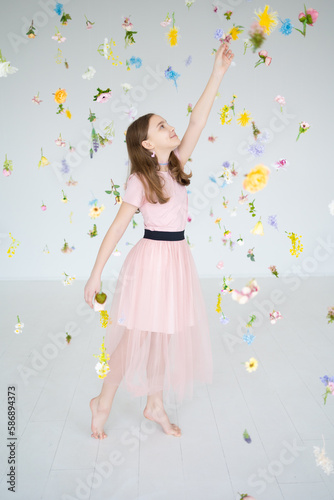 portrait of a girl in pink clothes in floating flowers